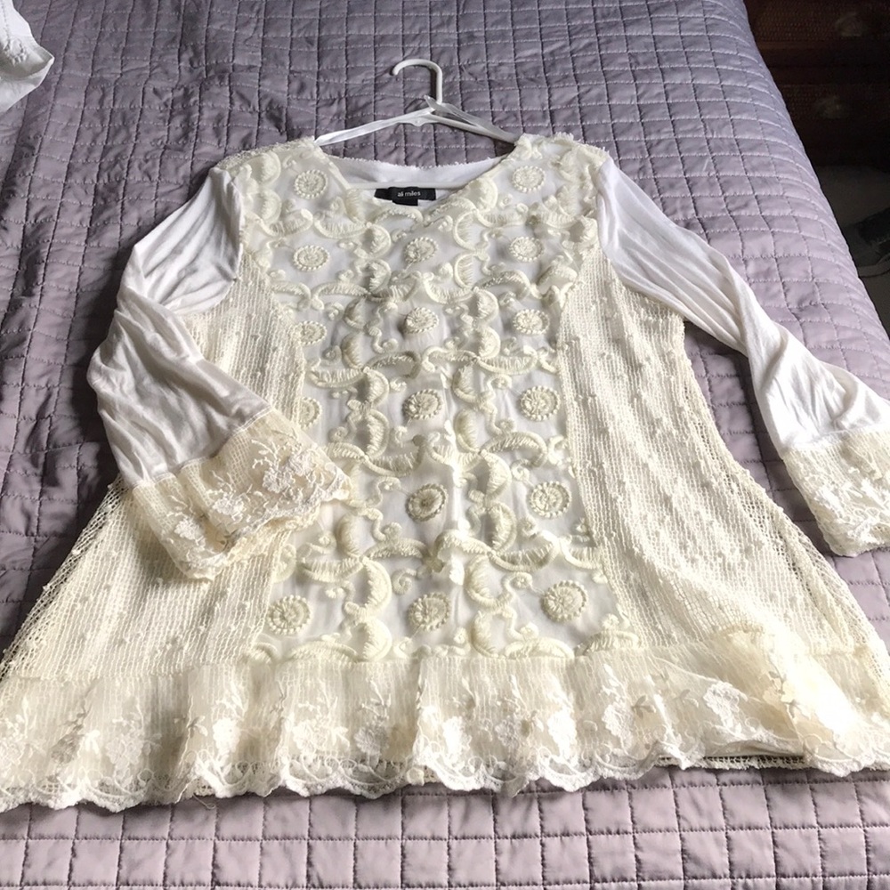 Cream top with clear sparkle rhinestones on back.